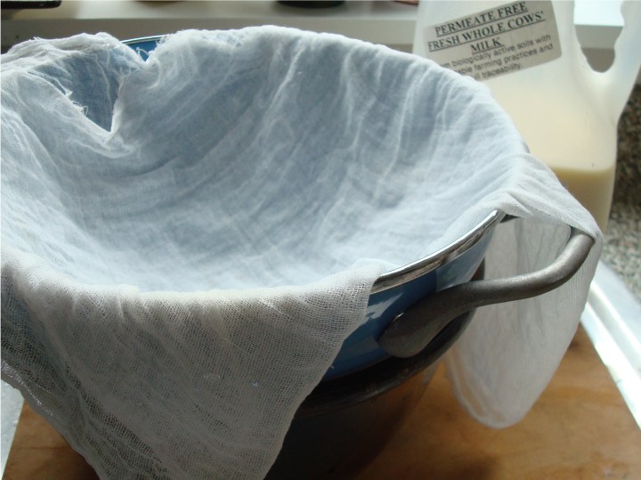 A colander with cheesecloth