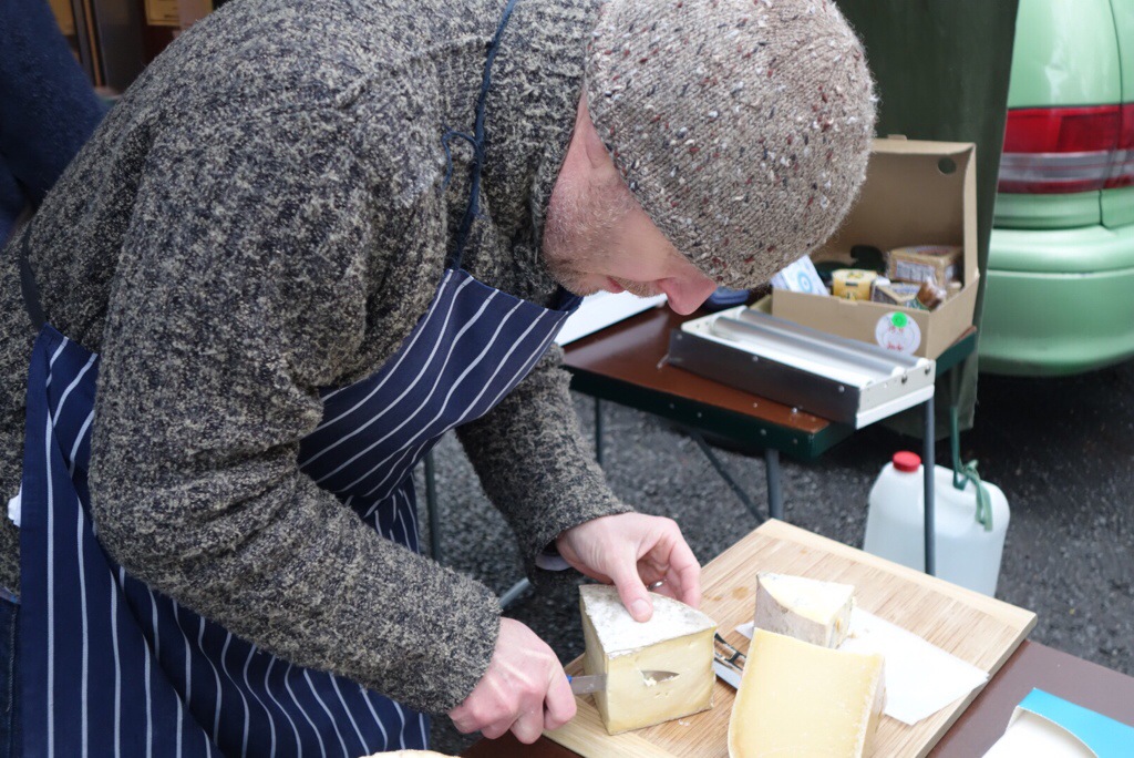 Wrapped up warmly Martin Aspinwall from Canterbury Cheesemongers slices some of the Caerphilly.